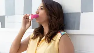Woman using an inhaler 